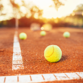 tennis balls inside the baseline