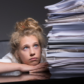 worker frustrated with unruly pile of documents