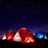 tents on campground with starry sky above